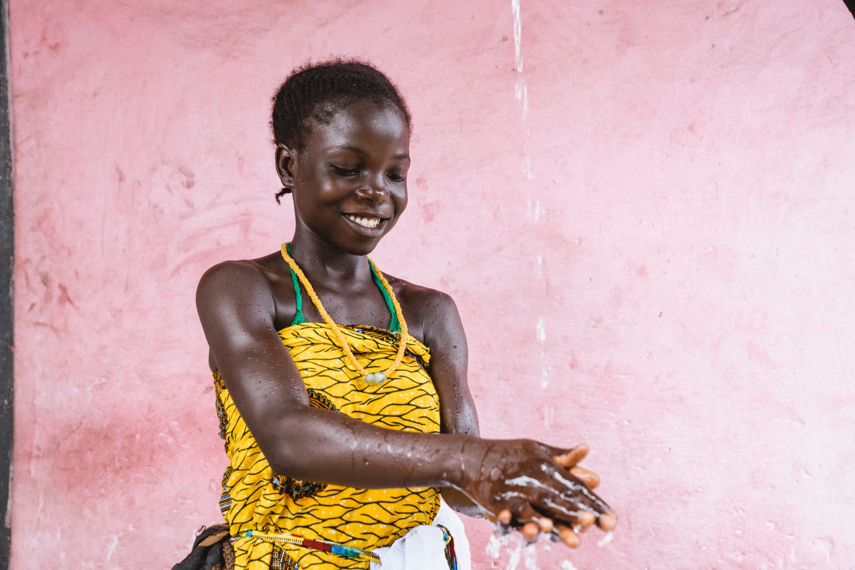 Young lady washes hands at new bathroom