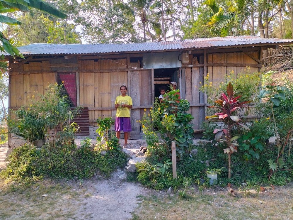 Families live in makeshift huts until their new homes are completed