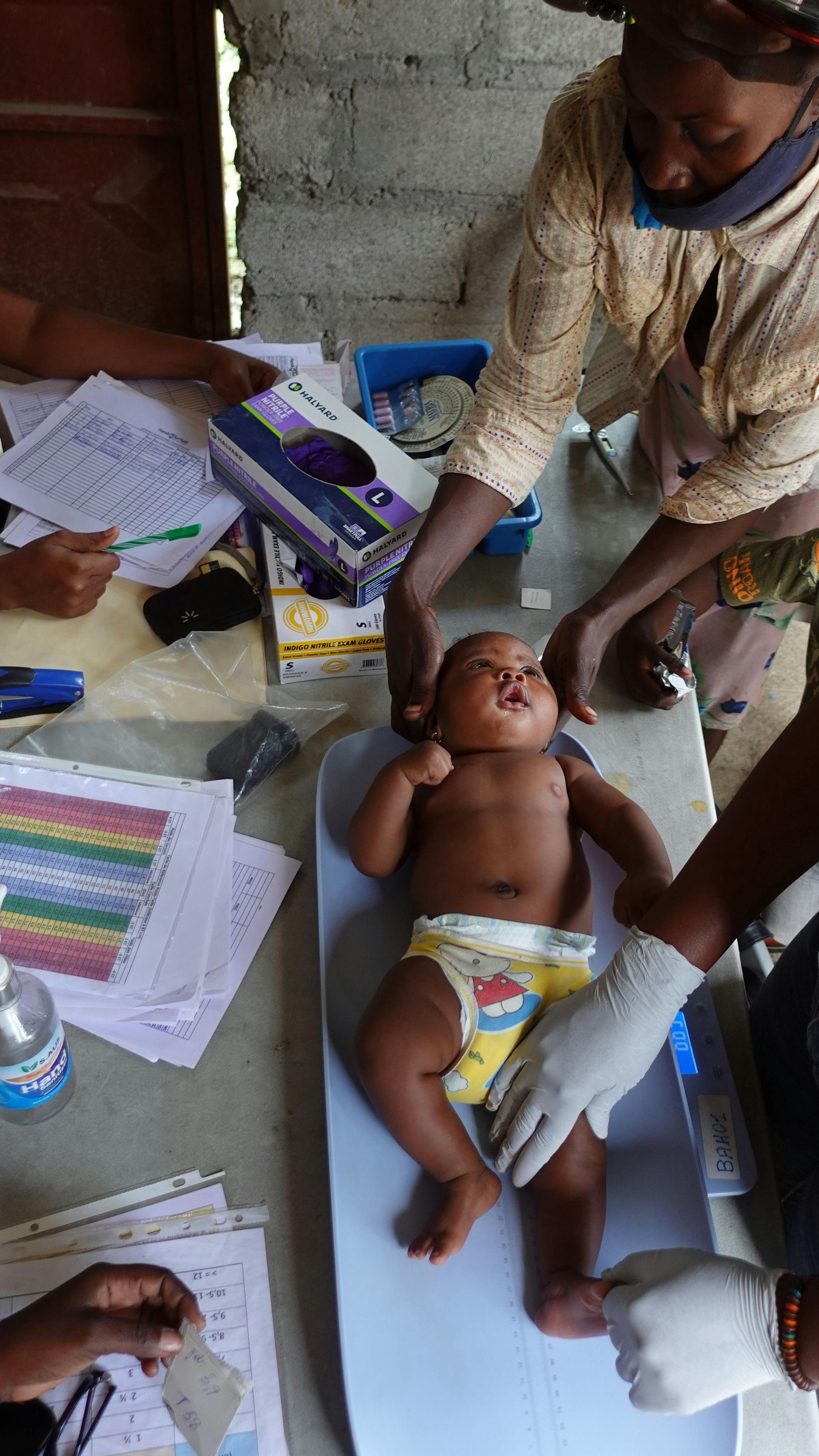 Baby receive medical checkup at clinic in Haiti